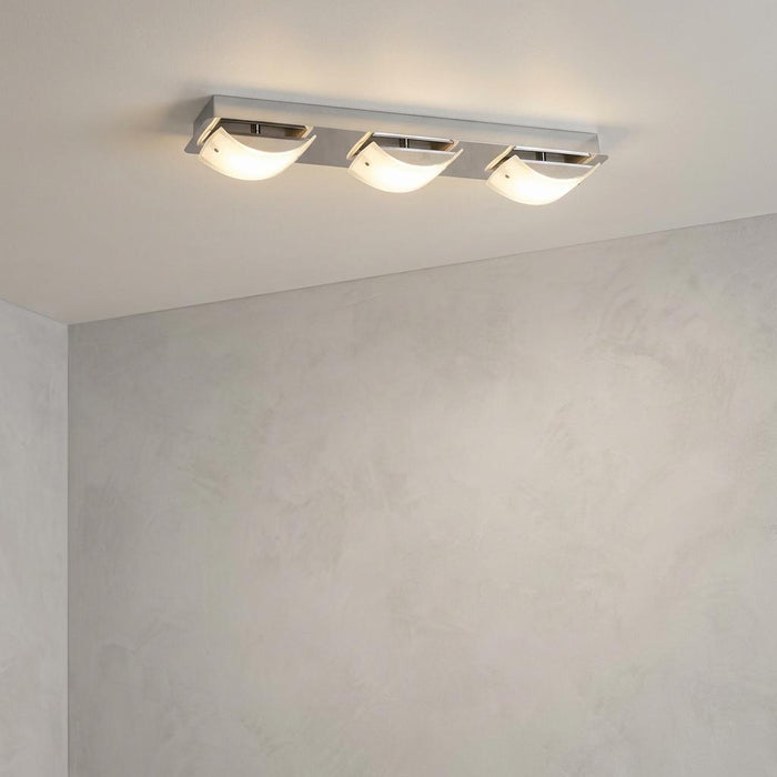 Modern three-light chrome LED ceiling fixture with curved frosted glass shades on a light gray ceiling.
