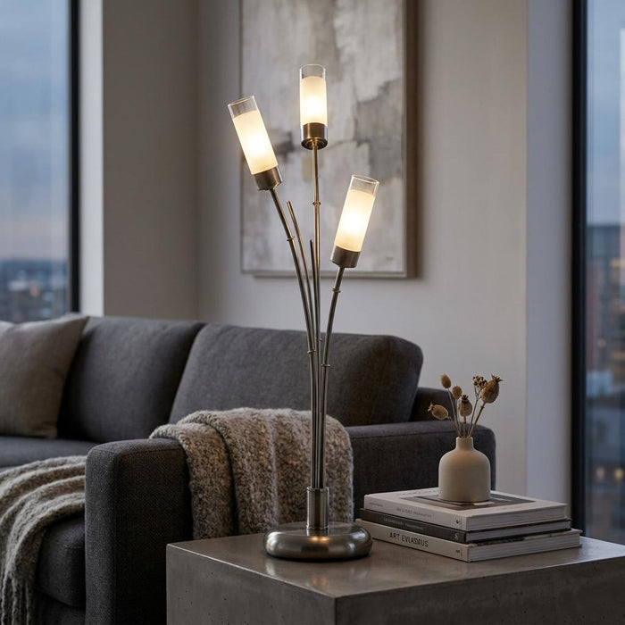 Oaks Oslo 3-light antique chrome table lamp with glowing frosted glass shades on a side table in a modern living room.