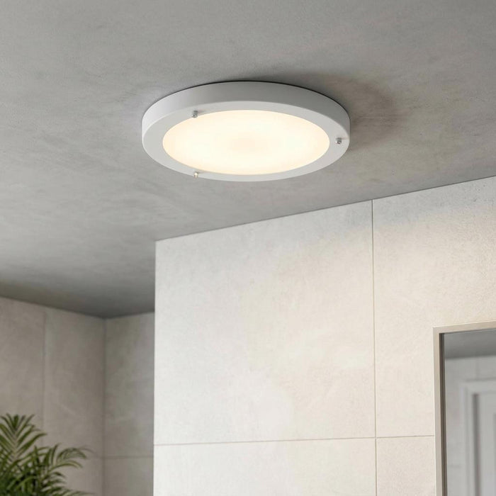 Round white flush ceiling light with a frosted glass diffuser and chrome clips mounted in a modern bathroom.