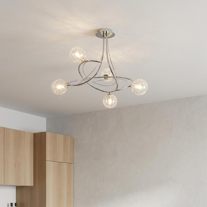 Modern chrome semi-flush ceiling light with five crackled glass globes, mounted on a white ceiling.