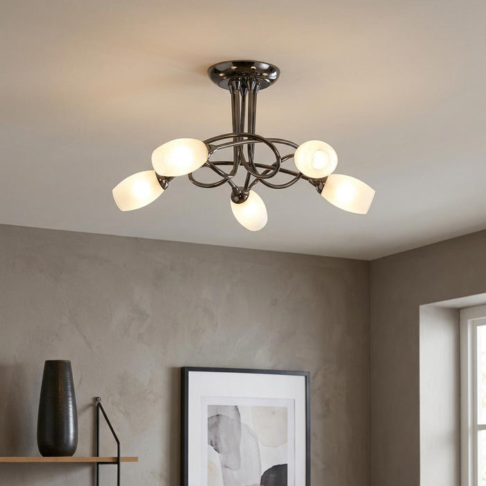 Modern 5-light semi-flush ceiling fixture in mirror black with oval frosted glass shades in a contemporary room.