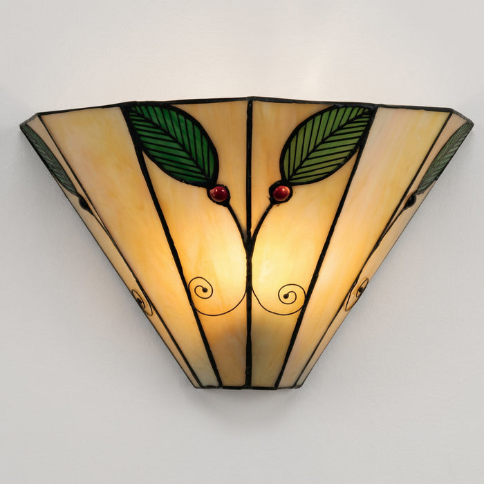 Decorative wall light fixture with leaf and berry design on a plain background