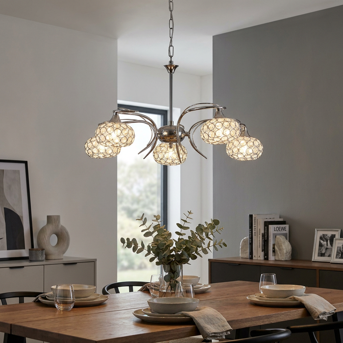Oaks Toulon 5-light chrome chandelier with crystal beaded globes hanging over a modern dining table.