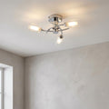 Ofira 3 Light Chrome Flush Ceiling Light with three cylindrical glass shades on a white ceiling.