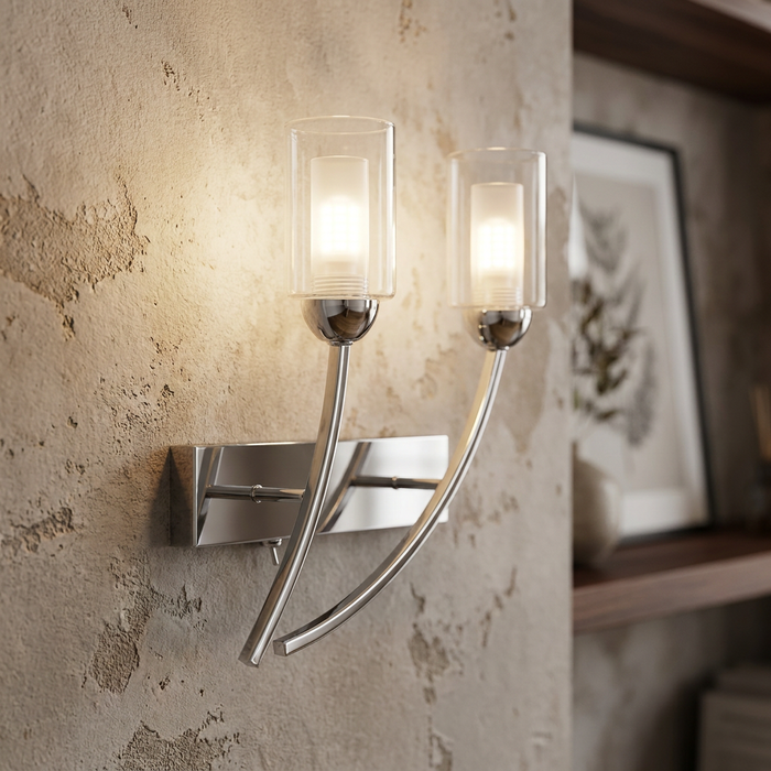 Modern chrome wall light with two curved arms and cylindrical glass shades against a textured wall.