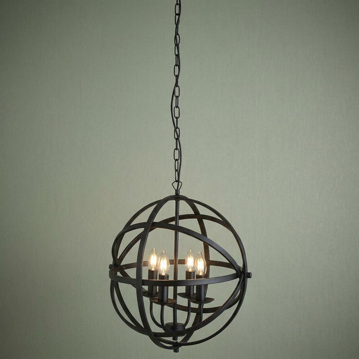 Black 4-light spherical cage pendant with candle-style bulbs against a textured sage green wall.