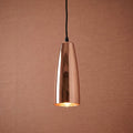 Polished copper cone-shaped pendant light hanging against a textured terracotta background.