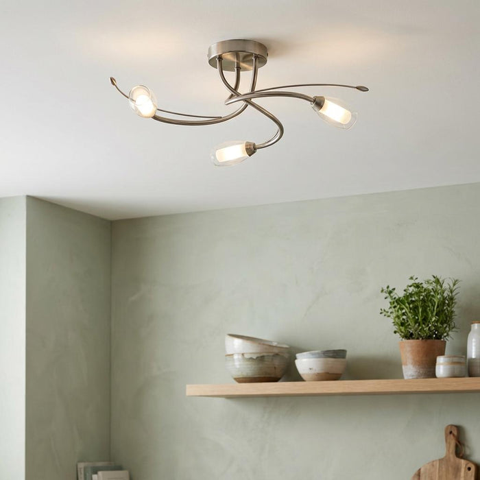 Pandora 3-light antique chrome flush ceiling light with curved arms and clear glass shades in a modern interior.