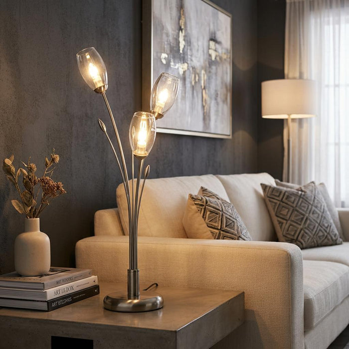 Three-light antique chrome table lamp with tulip glass shades on a side table in a modern living room.