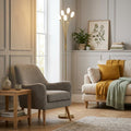 Pandora antique brass floor lamp with five white tulip shades illuminating a cozy living room with grey armchair.