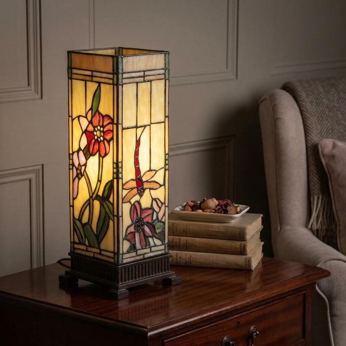 Rectangular Tiffany lamp featuring floral and dragonfly stained glass designs on a dark wood table.