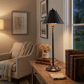 Provence bronze stick table lamp with a conical shade on a wooden desk in a cozy interior.