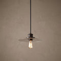 Quoizel Admiral bronze pendant light with a clear textured glass disk shade and a vintage-style bulb.