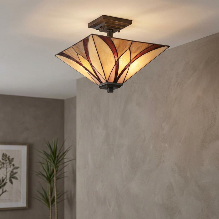 A square Tiffany-style semi-flush ceiling light with amber and red stained glass in a contemporary room.