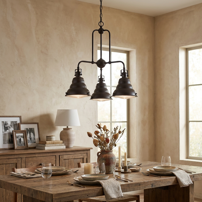 Palladian bronze 3-light industrial chandelier hanging above a rustic wooden dining table in a cozy dining room.