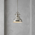 Polished silver mini pendant ceiling light with an industrial-style bell shade against a grey textured wall.