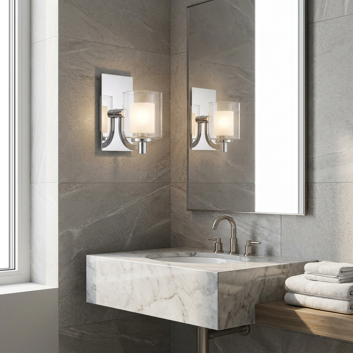 Modern chrome wall light with double glass shades mounted in a contemporary marble and grey tiled bathroom.