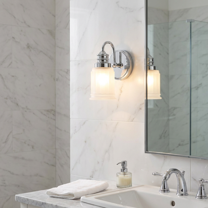 Quoizel Swell 1 Light Chrome Bathroom Wall Light with a frosted glass shade mounted on a marble wall next to a mirror.