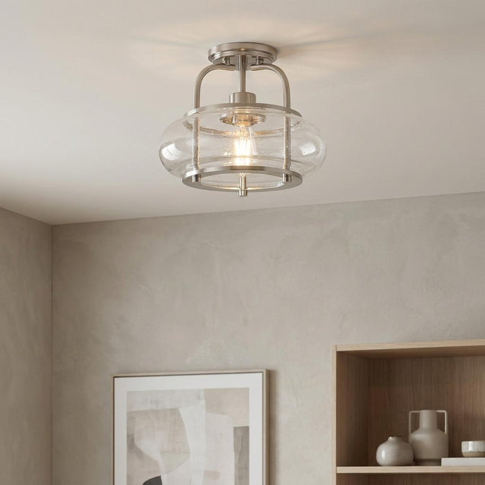 Quoizel Trilogy semi-flush ceiling light with a brushed nickel finish and seeded glass globe in a neutral room.