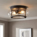 Bronze flush mount ceiling light with a clear seeded glass shade and two warm Edison-style bulbs.