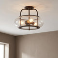 Bronze semi-flush ceiling light featuring a clear seeded glass shade and warm Edison bulbs.