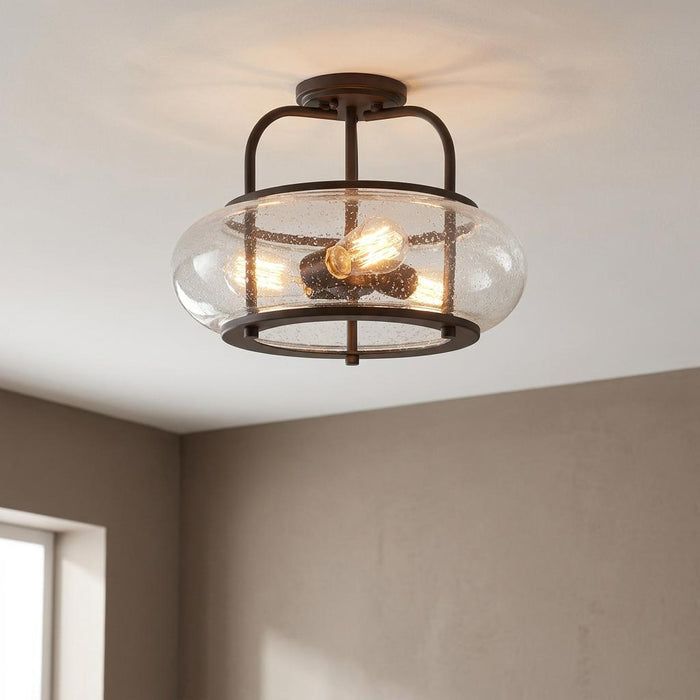 Bronze semi-flush ceiling light featuring a clear seeded glass shade and warm Edison bulbs.