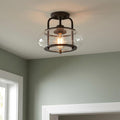 Quoizel Trilogy semi-flush ceiling light with an old bronze frame and seedy glass shade illuminating a room.