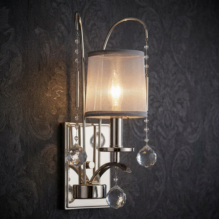 Quoizel Whitney 1 light silver wall sconce with a mesh shade and crystal drops against dark damask wallpaper.