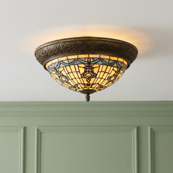 Regency Flush Tiffany Ceiling Light featuring intricate stained glass and ornate bronze trim on a white ceiling.