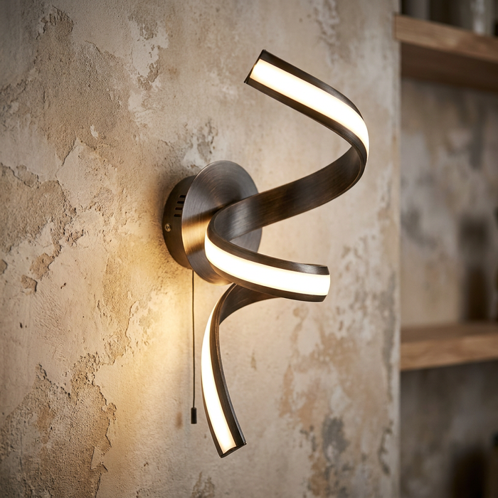 A twisting LED ribbon wall light in an antique brown and gold finish, mounted on a textured wall.