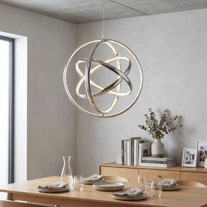Modern Rings 3 Light LED chrome and crystal gyro pendant light hanging above a minimalist wooden dining table.