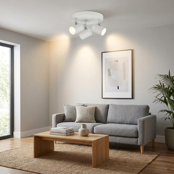Rollo 3-light white cylinder head flush adjustable spotlight mounted in a modern grey living room.