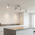 Rollo 4 light chrome adjustable split bar ceiling spotlights illuminating a modern white kitchen island.