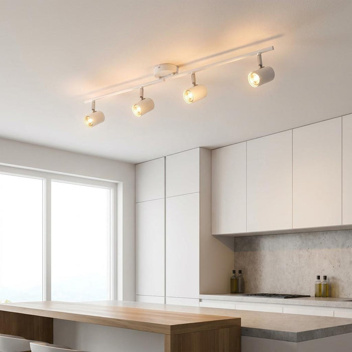 Rollo 4 Light Adjustable White Split Bar Ceiling Spotlights illuminating a modern white and wood kitchen.