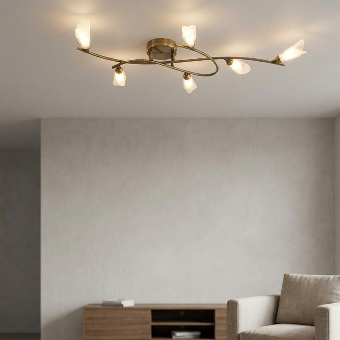 Sare 6 light antique brass ceiling fixture with petal-shaped glass shades in a modern living room setting.