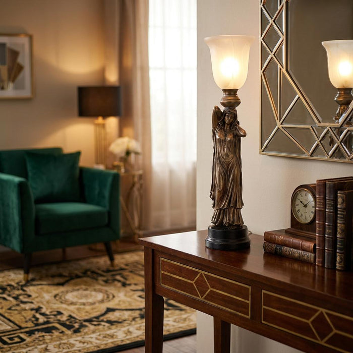 Art Deco figurine lamp with a frosted glass shade on a wooden console table in a stylish living room.
