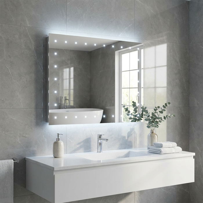 Rectangular LED bathroom mirror with 20 square lights mounted on a grey tiled wall above a white vanity.