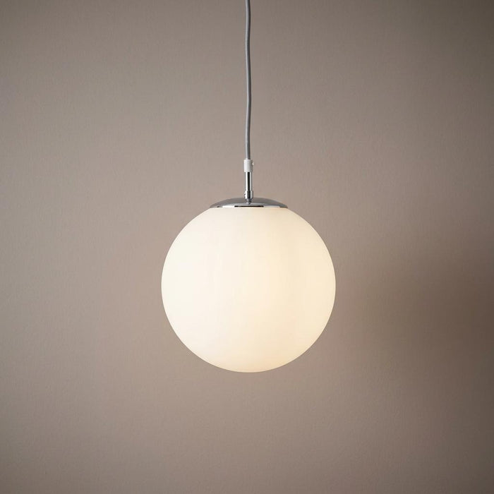 Modern opal glass globe ceiling pendant with silver chrome fixture against a neutral background.