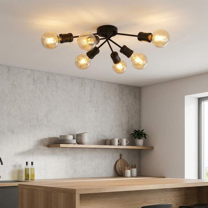 Searchlight Dance 6 light black flush spot ceiling light with warm exposed bulbs in a modern kitchen.