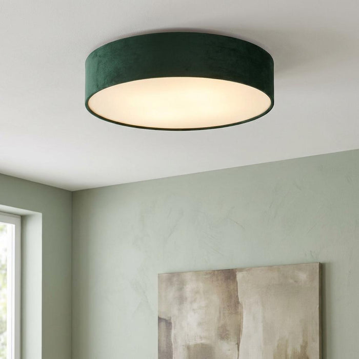 Searchlight drum ceiling flush light with a green velvet shade, illuminated and mounted on a white ceiling.