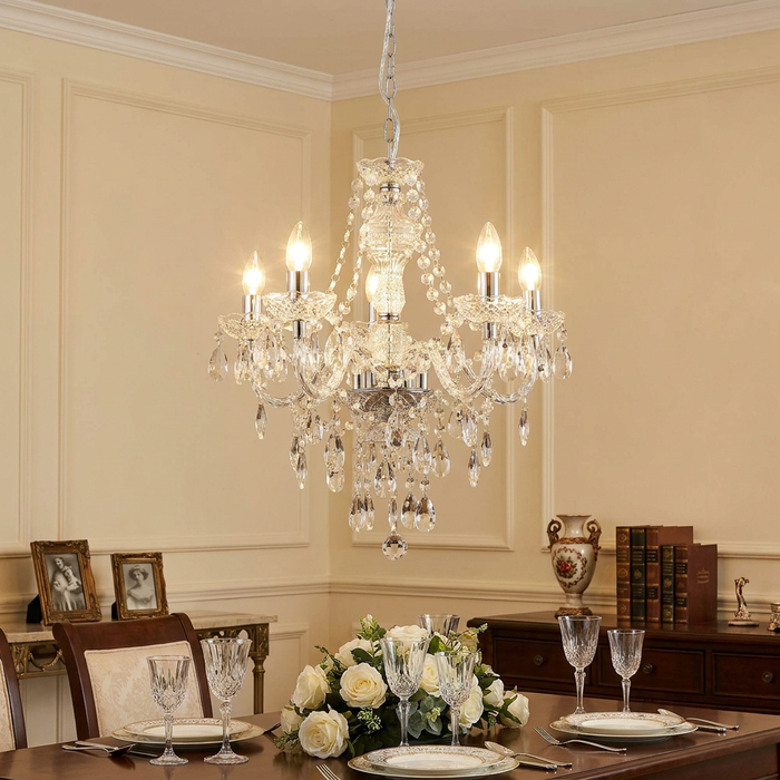 Searchlight Marie Therese 5 light clear acrylic chandelier hanging over a formal dining table with place settings.