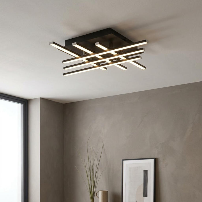 Modern black LED ceiling flush light with a crisscross bar design in a contemporary interior setting.