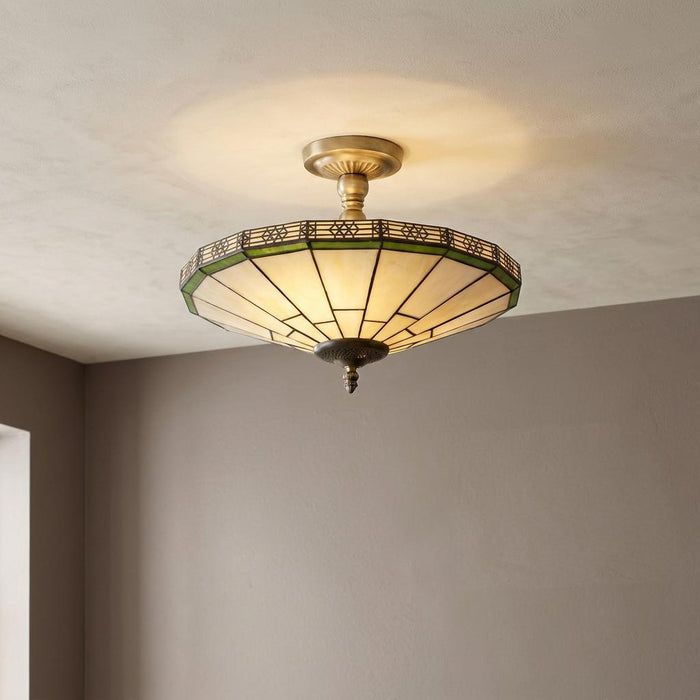 Art Deco semi-flush Tiffany ceiling light with cream and green glass panels and an antique brass mount.