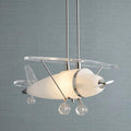 Novelty airplane pendant light with an illuminated frosted glass body, chrome propeller, and clear acrylic wings.