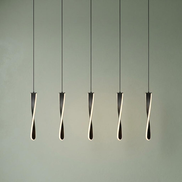 Five black twisted LED pendant lights suspended in a row against a light green wall.