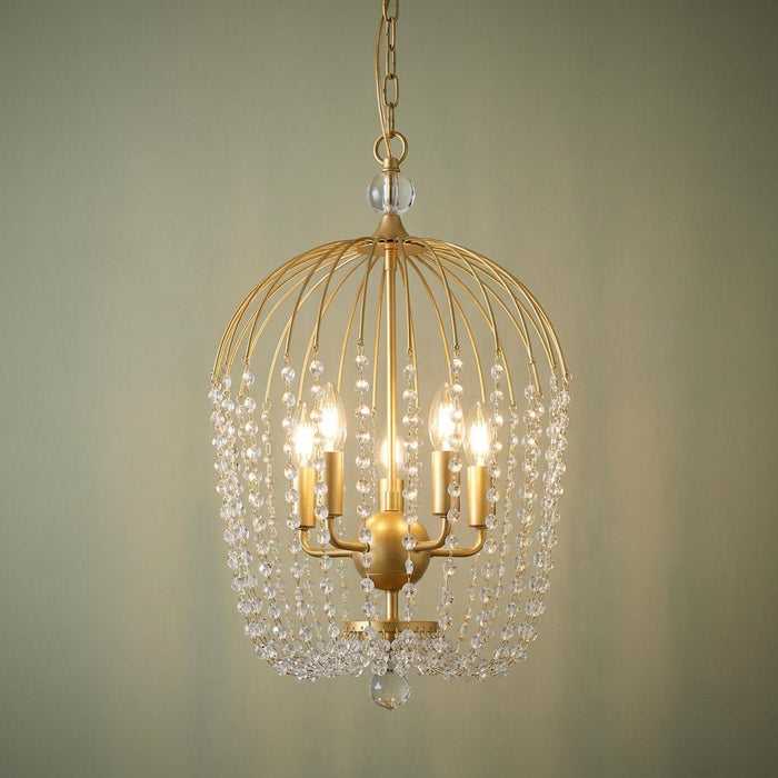 Gold cage pendant light with cascading crystal beads and five glowing candle-style bulbs.