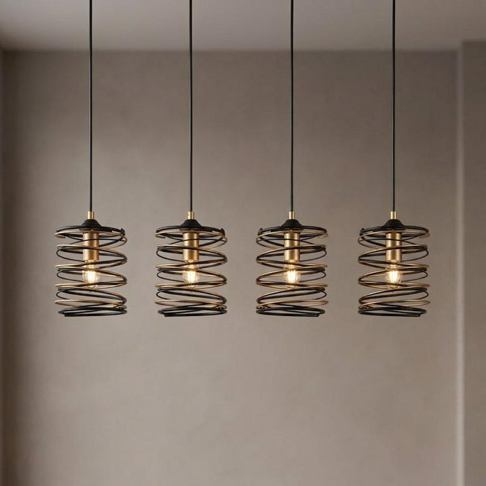 Four black and gold spiral pendant lights with exposed bulbs hanging against a neutral wall.