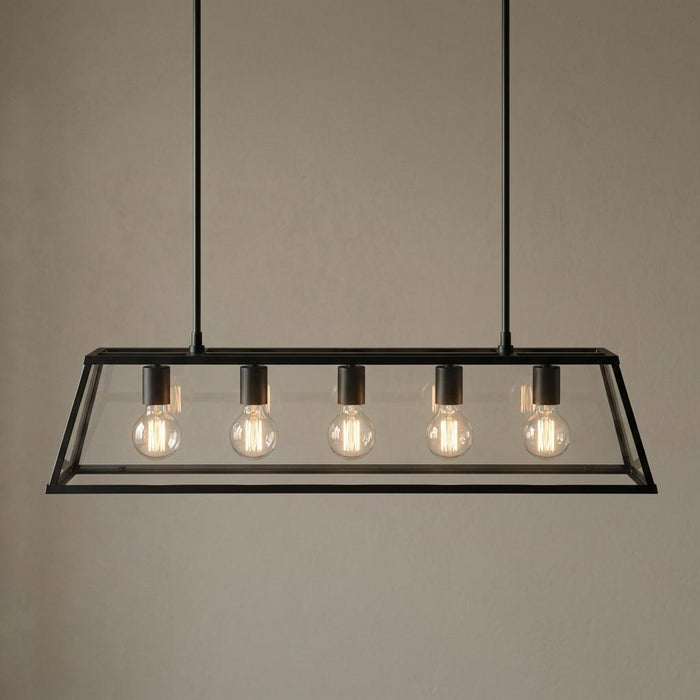 Searchlight Voyager five-light black and glass lantern bar pendant against a neutral wall.