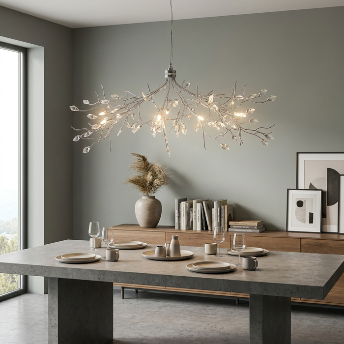 Silver branch-style 8-light pendant with crystal leaves over a minimalist dining table in a contemporary room.