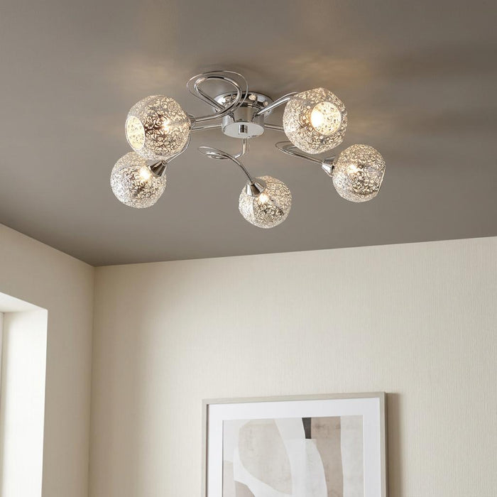 Souk 5-light chrome ceiling flush mount with intricate fretwork patterned shades in a modern room setting.